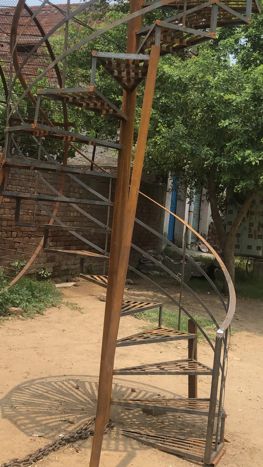 Full-height industrial spiral stair frame under fabrication