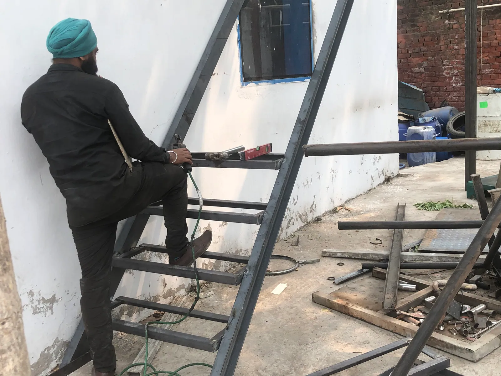 Worker fabricating a custom steel stair frame