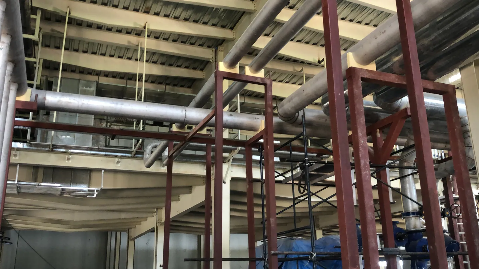 Stainless steel industrial pipelines installed on structural supports
