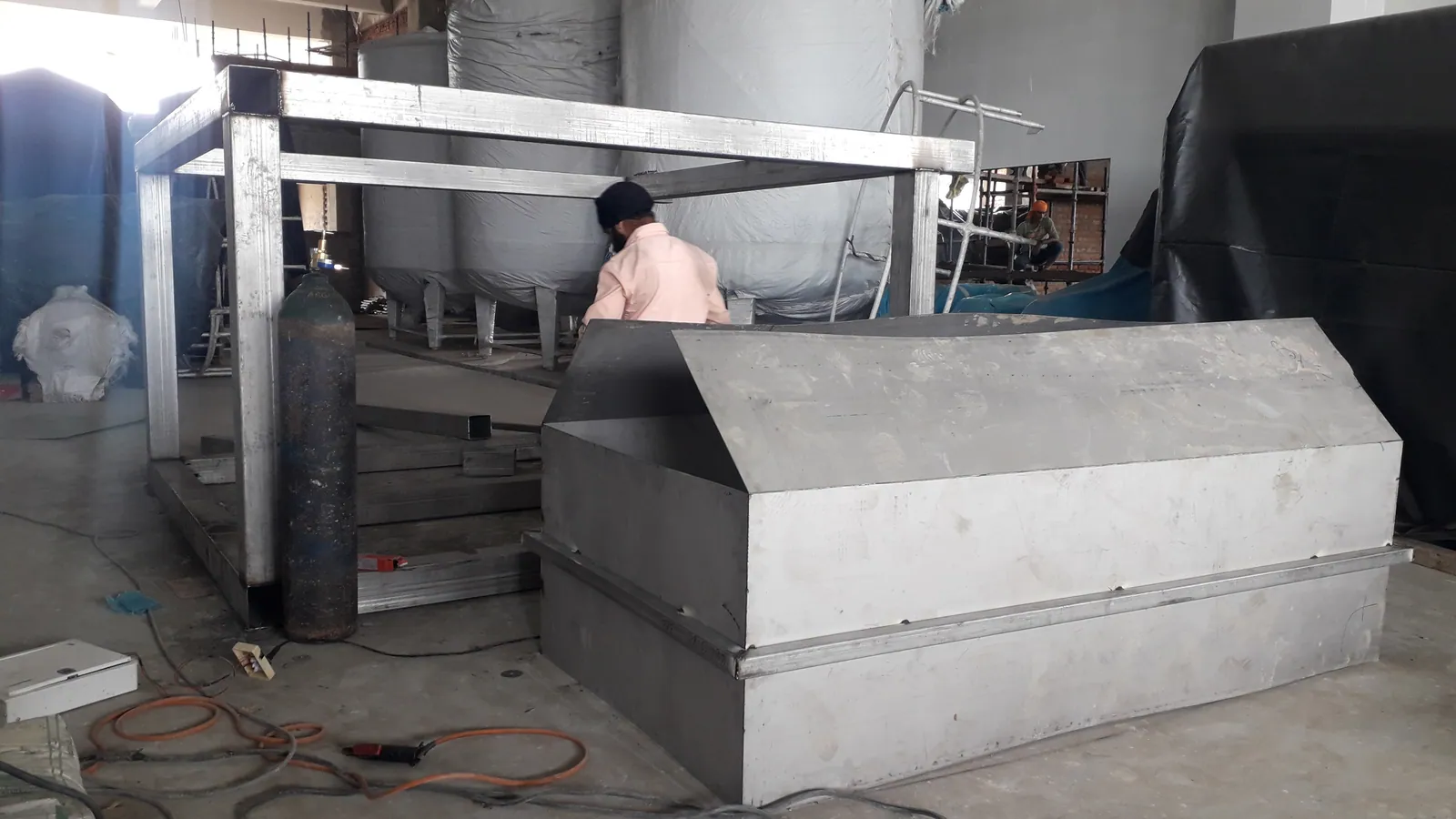 Custom stainless steel tank fabrication work in an industrial workshop