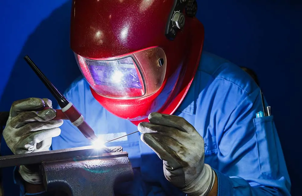 TIG welder preparing a controlled stainless steel pipe weld